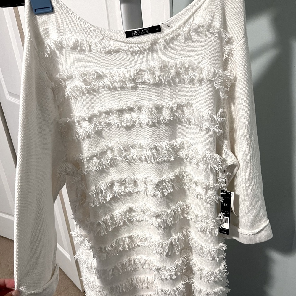 It’s a never worn before NIC+ZOE sweater in size 1X. It is originally $178.